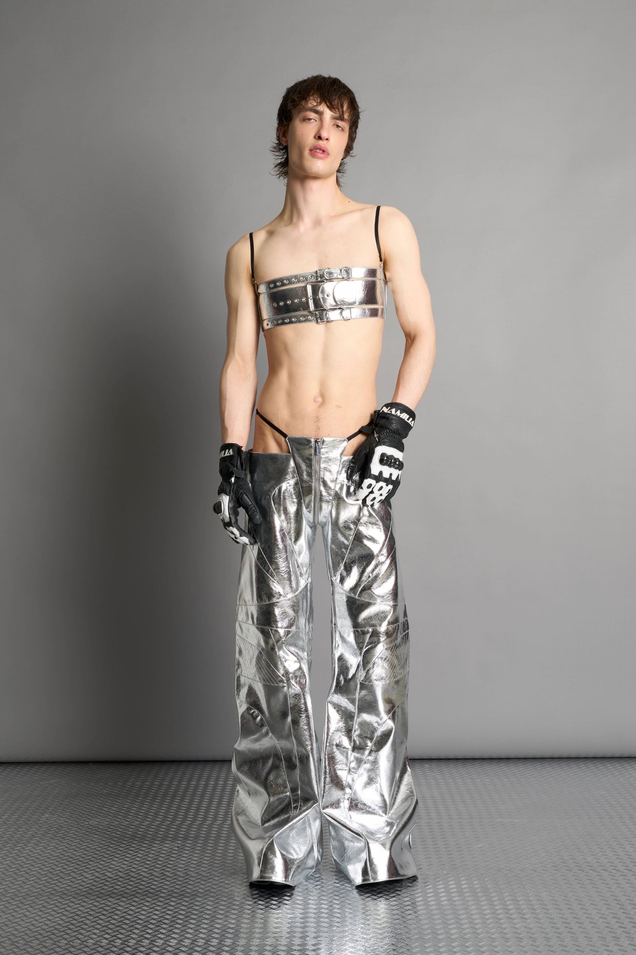 silver vegan leather belt top with three adjustable grommet straps, oversized metal buckles, and circular hardware – edgy bondage-inspired crop top for festival or clubwear.