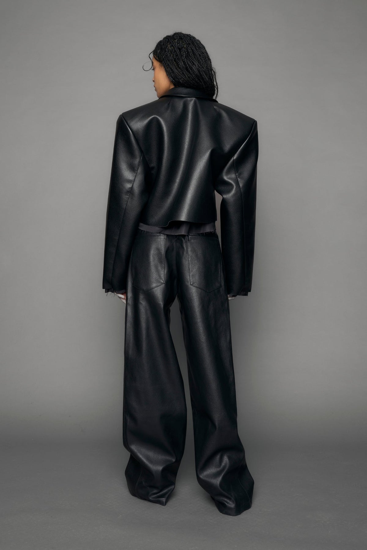 model wearing black vegan leather blazer cropped