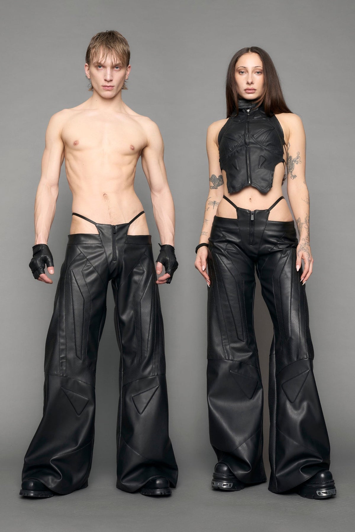 model wearing black vegan leather perforated thong pants