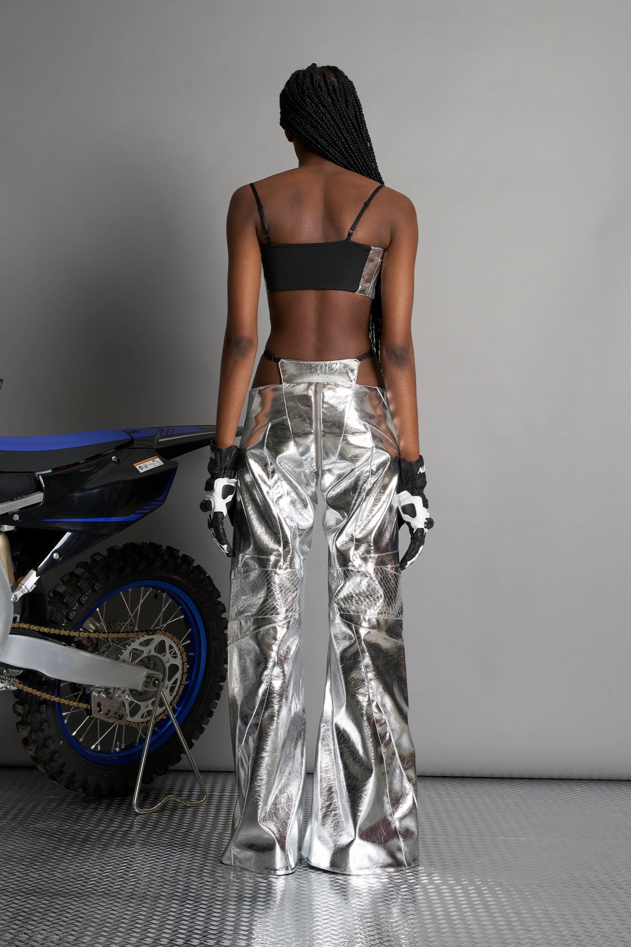 silver vegan leather belt top with three adjustable grommet straps, oversized metal buckles, and circular hardware – edgy bondage-inspired crop top for festival or clubwear.
