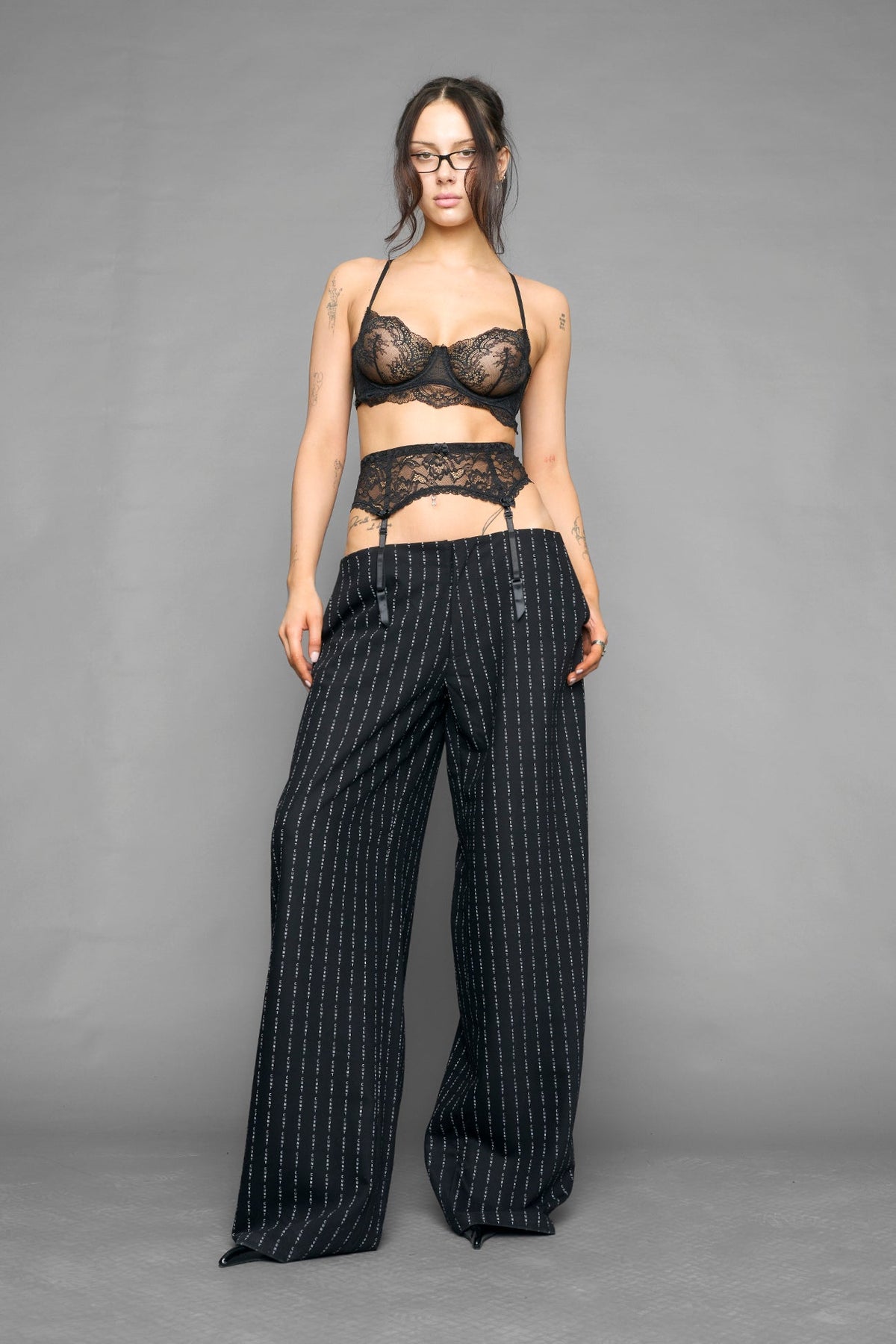 model wearing suspender lace office baggy pants in wool blend