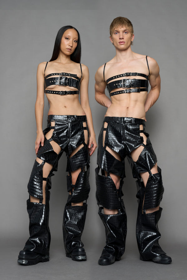 model wearing black vegan leather croc optic pants with cut outs