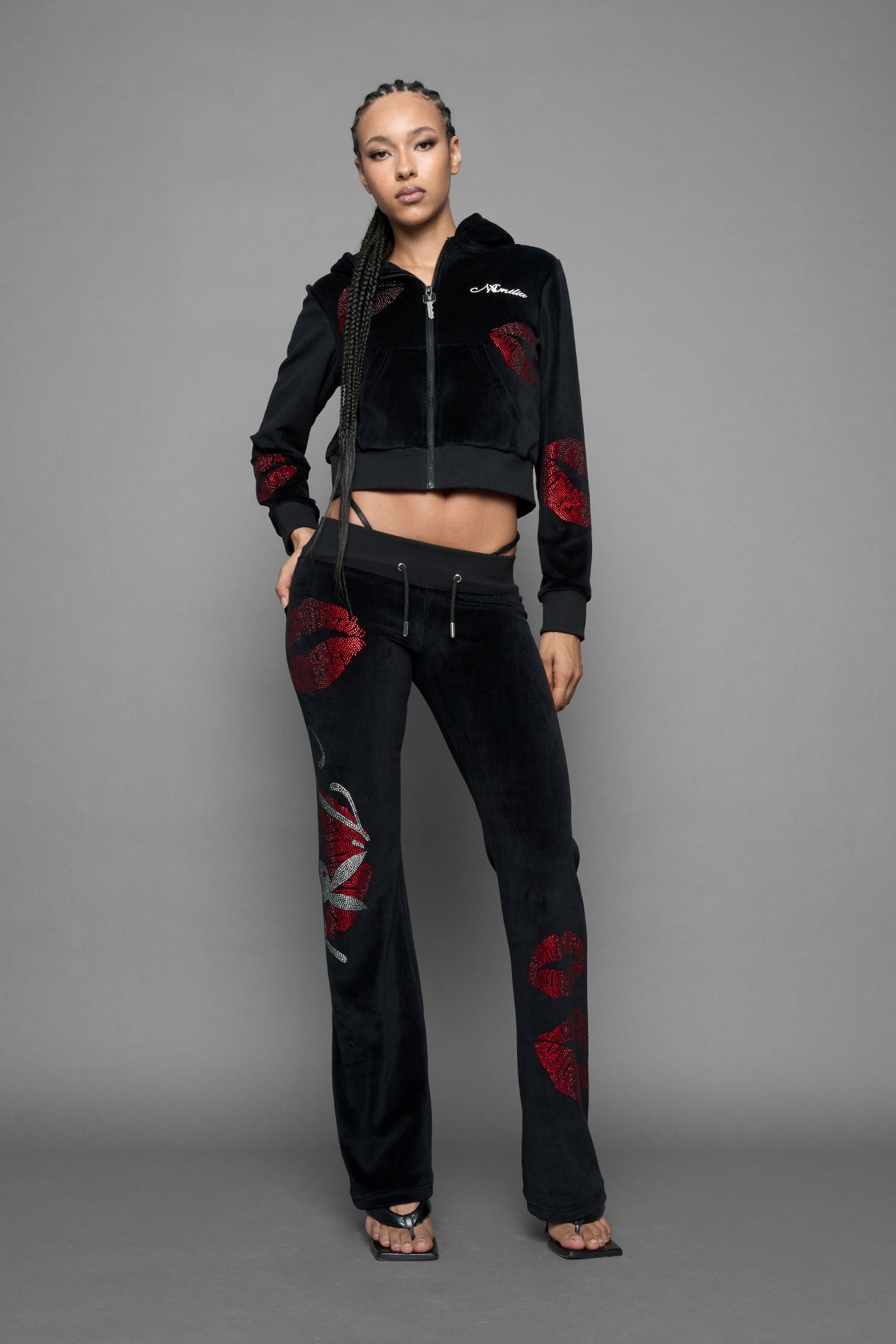 model wearing black red crystal embroidered jogger pants 