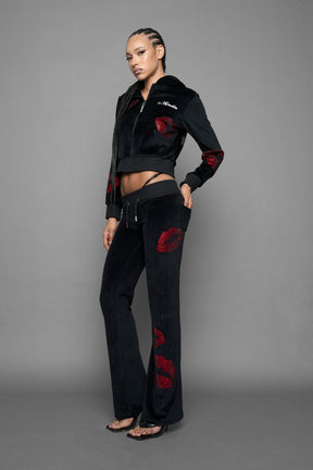model wearing black red crystal embroidered jogger pants 