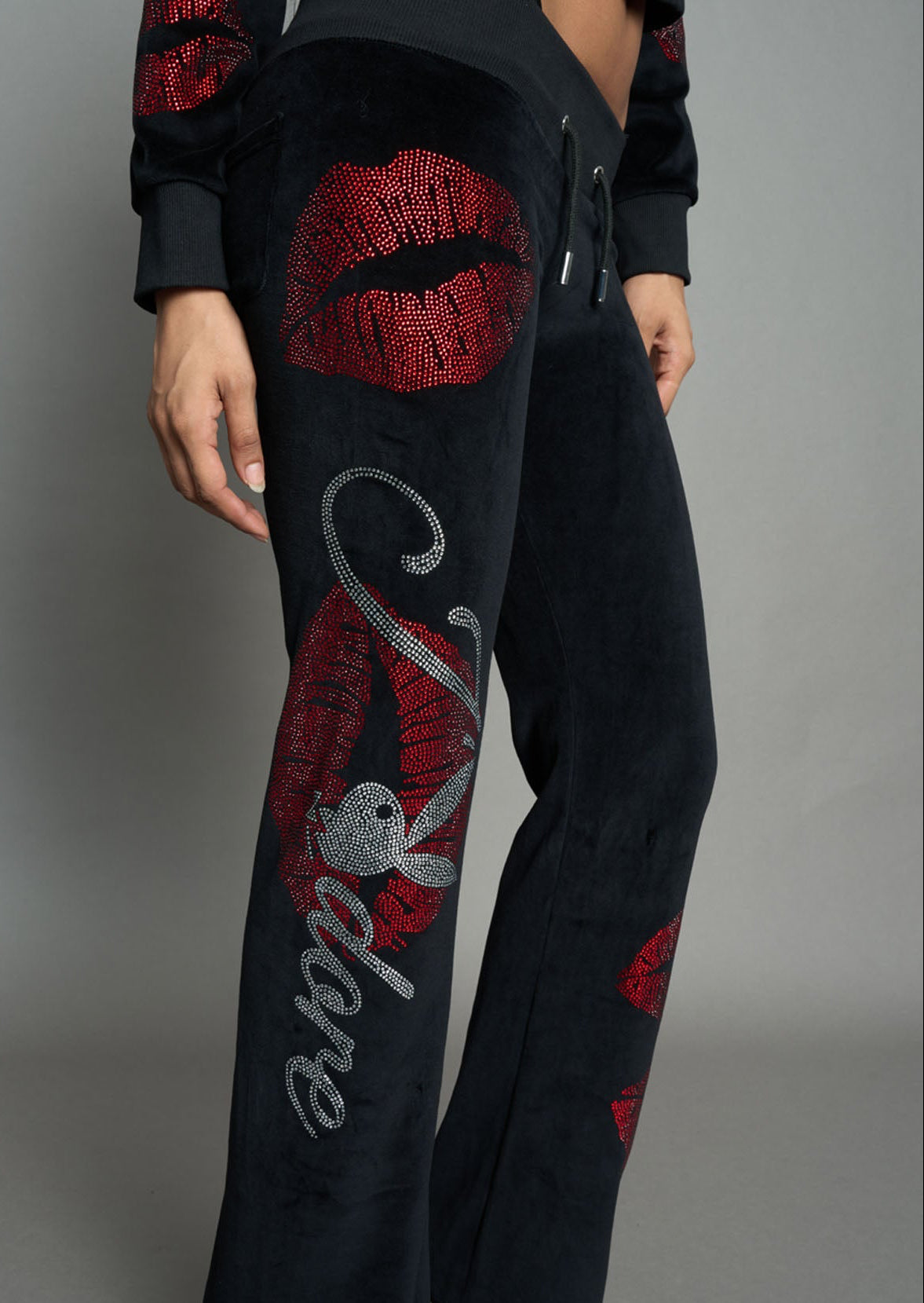 model wearing black red crystal embroidered jogger pants 