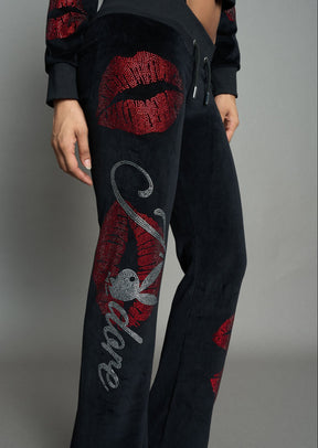 model wearing black red crystal embroidered jogger pants 