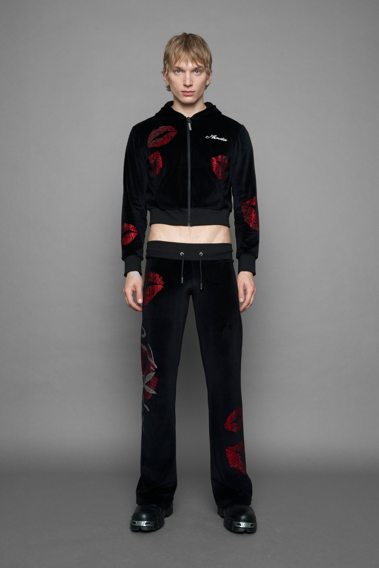 model wearing black red crystal embroidered jogger pants 