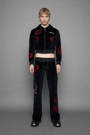model wearing black red crystal embroidered jogger pants 