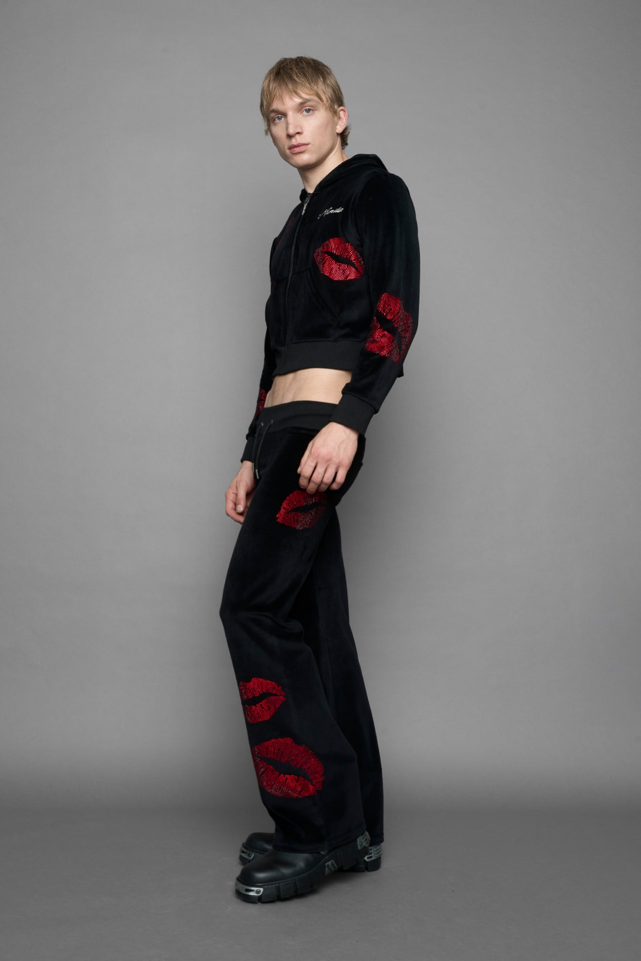 model wearing black red crystal embroidered jogger pants 