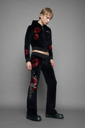 model wearing black red crystal embroidered jogger pants 