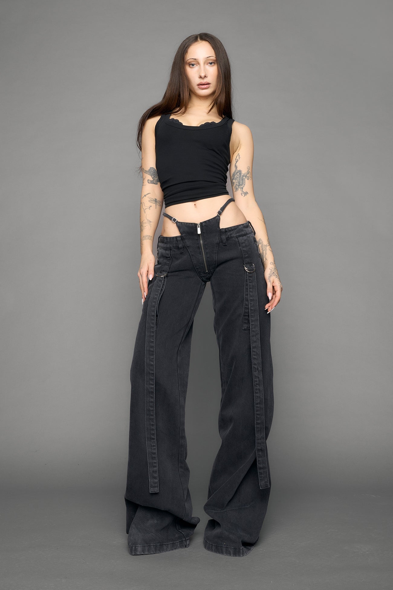 model wearing black grey denim with belt and thong