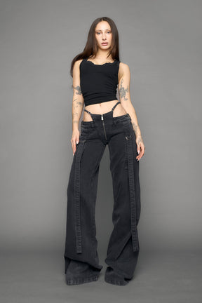 model wearing black grey denim with belt and thong