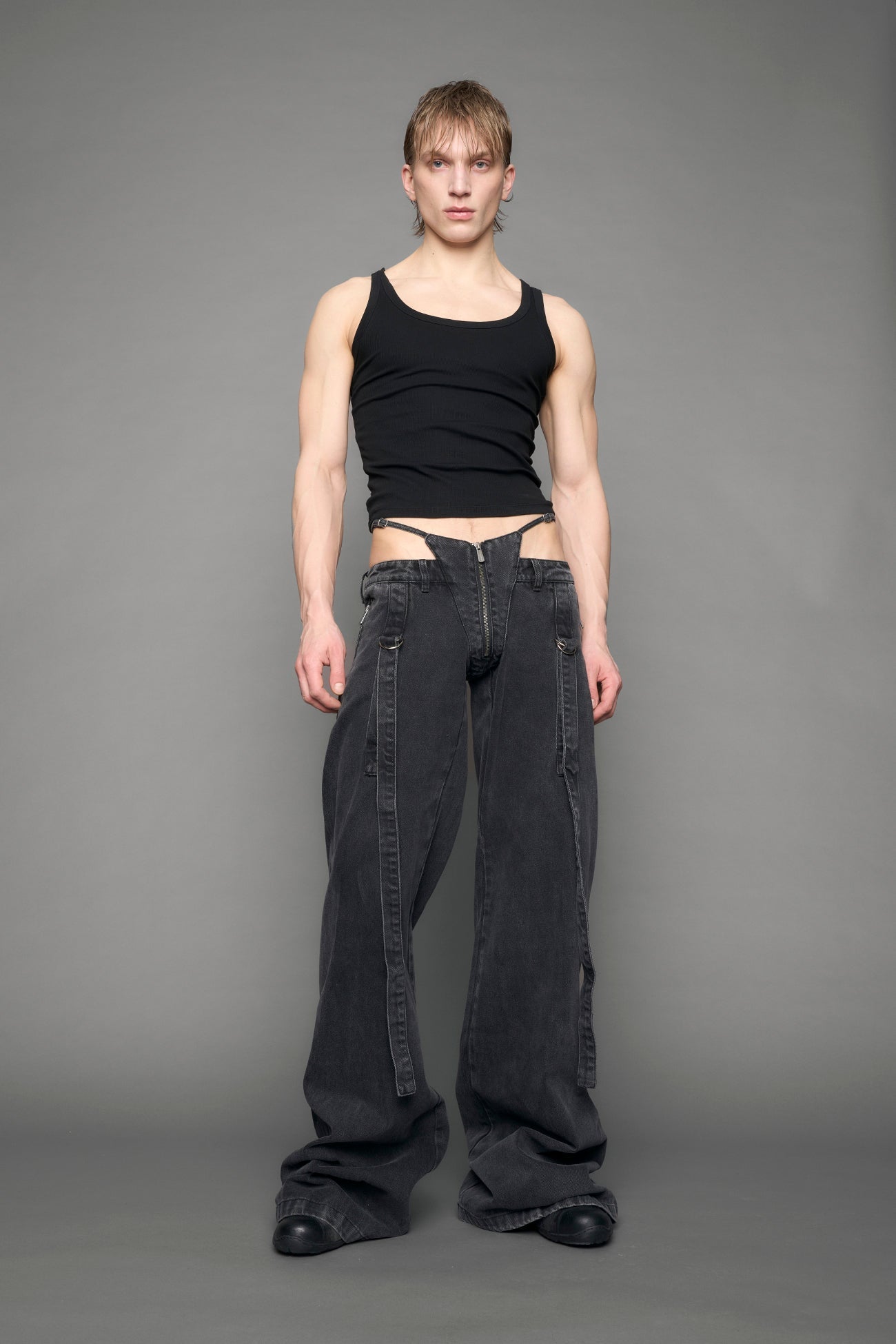 model wearing black grey denim with belt and thong