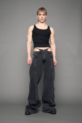 model wearing black grey denim with belt and thong