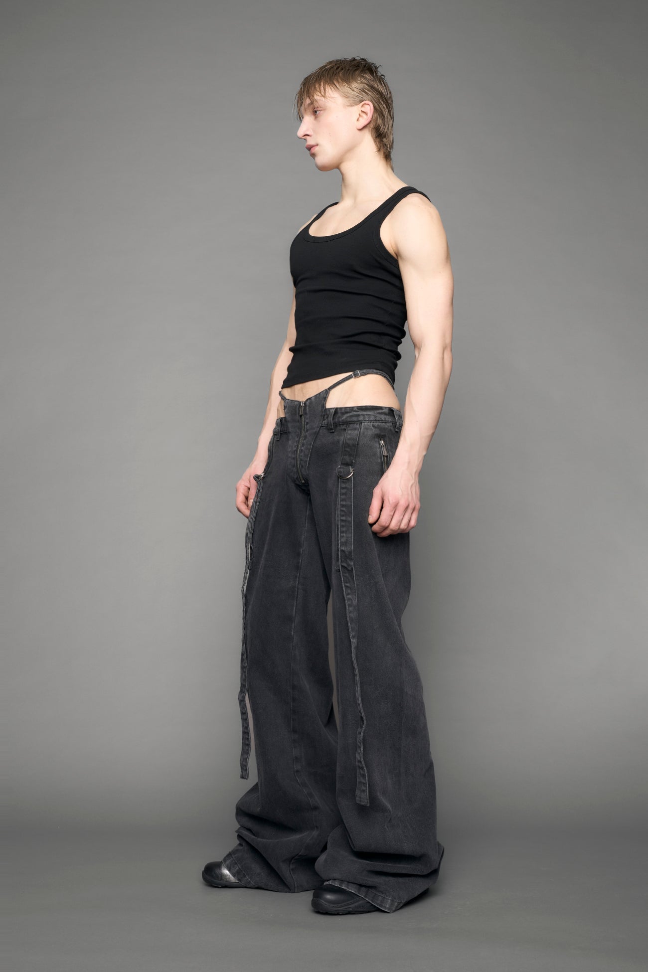 model wearing black grey denim with belt and thong