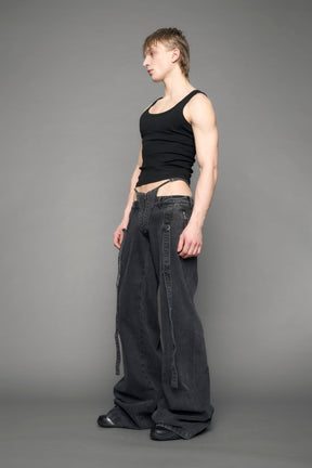 model wearing black grey denim with belt and thong