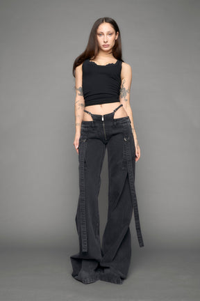 model wearing black grey denim with belt and thong