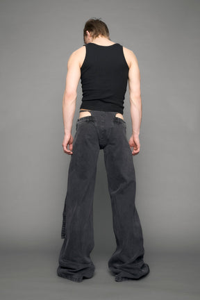 model wearing black grey denim with belt and thong