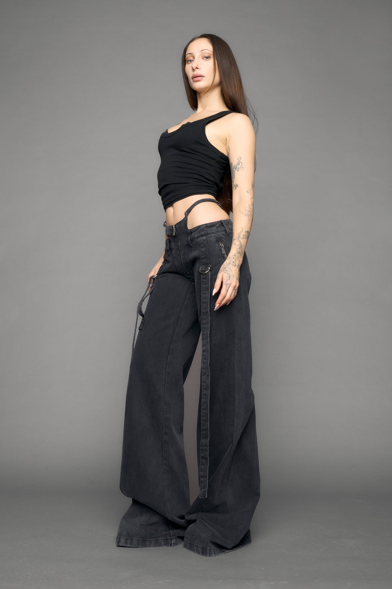 model wearing black grey denim with belt and thong