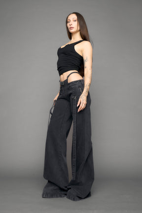 model wearing black grey denim with belt and thong