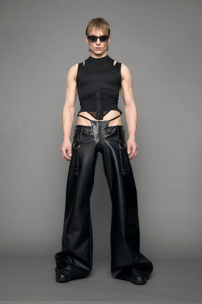 model wearing black vegan leather denim thong pants with belt detail