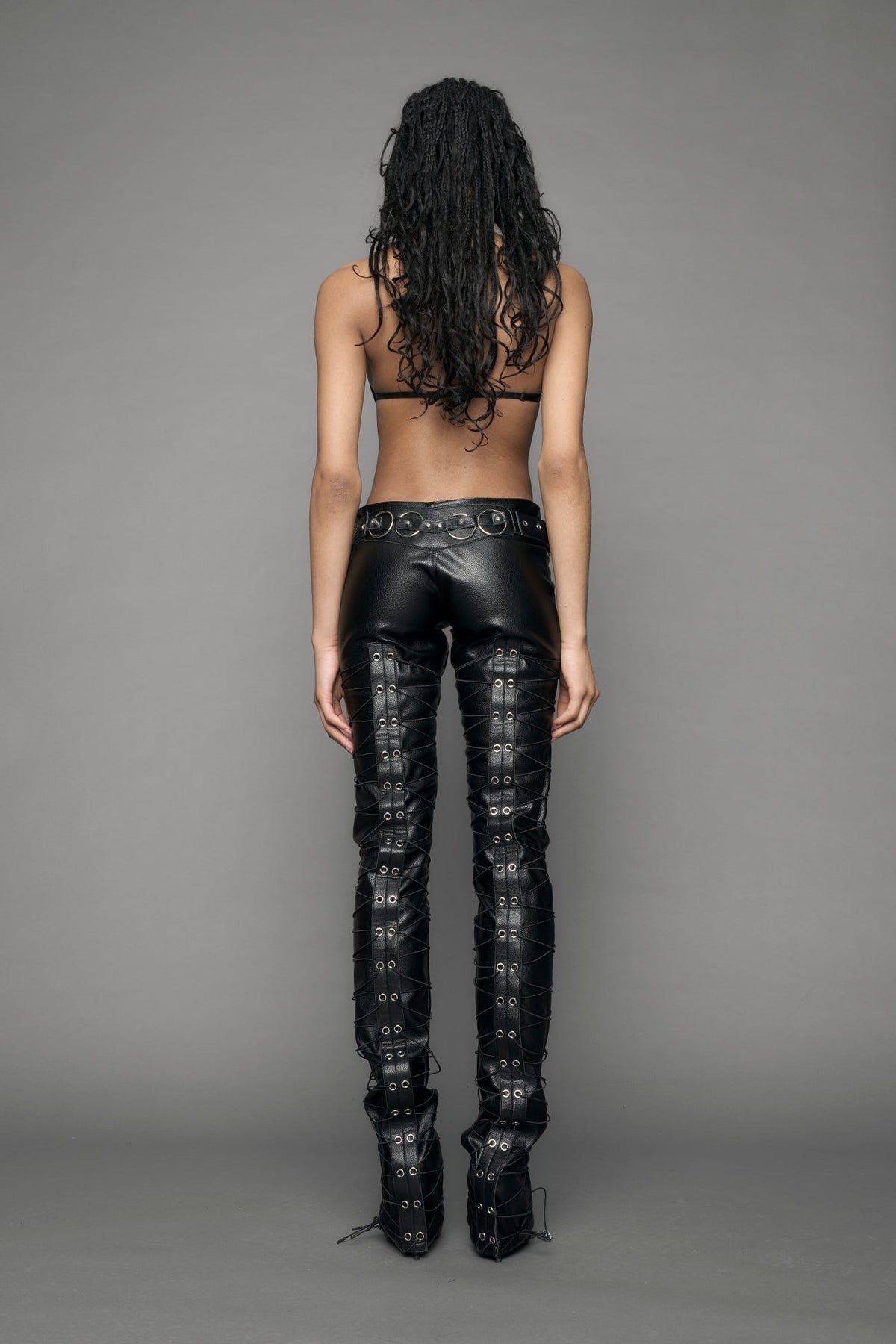 model wearing black vegan leather low waist skinny pants