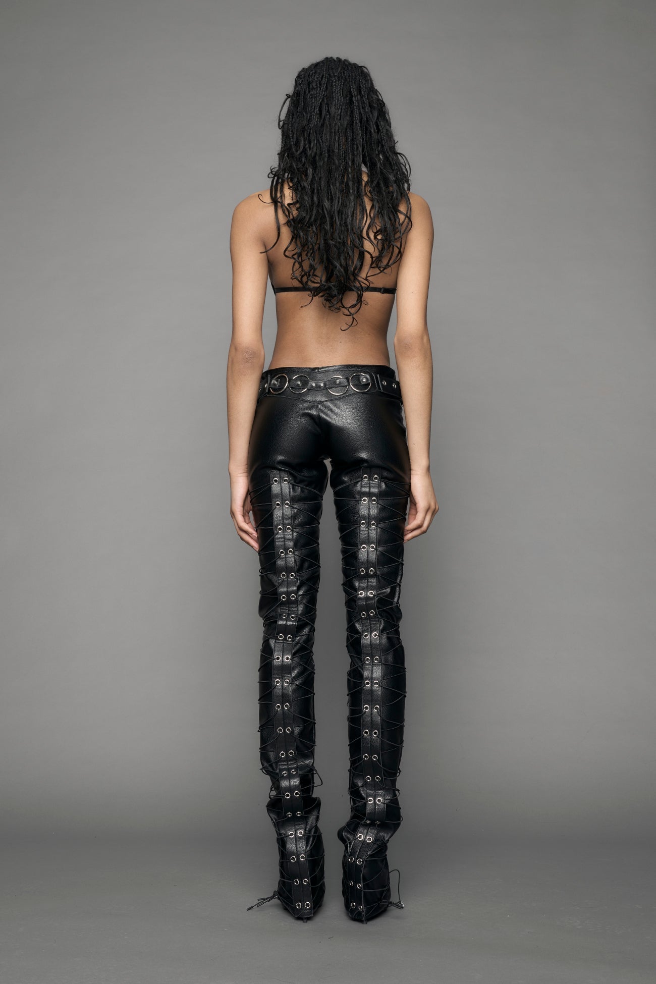 model wearing black vegan leather low waist skinny pants