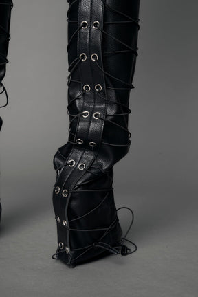 model wearing black vegan leather low waist skinny pants