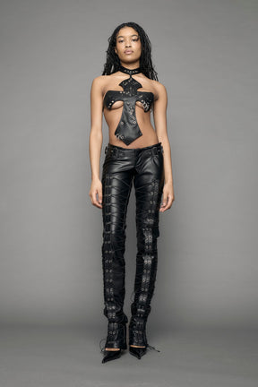 model wearing black vegan leather low waist skinny pants