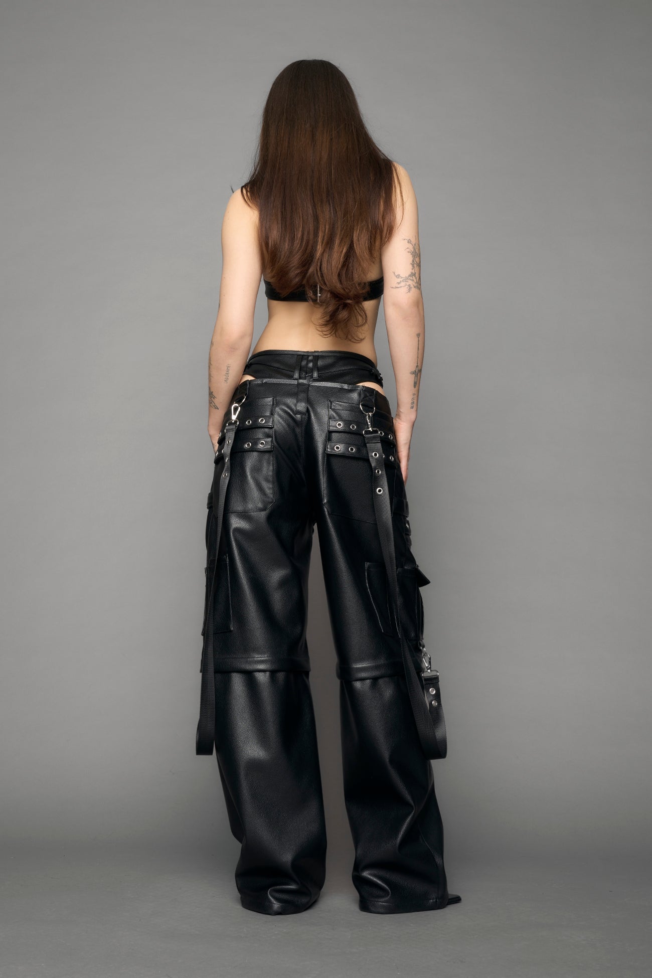 model wearing black vegan leather cargo panty pants