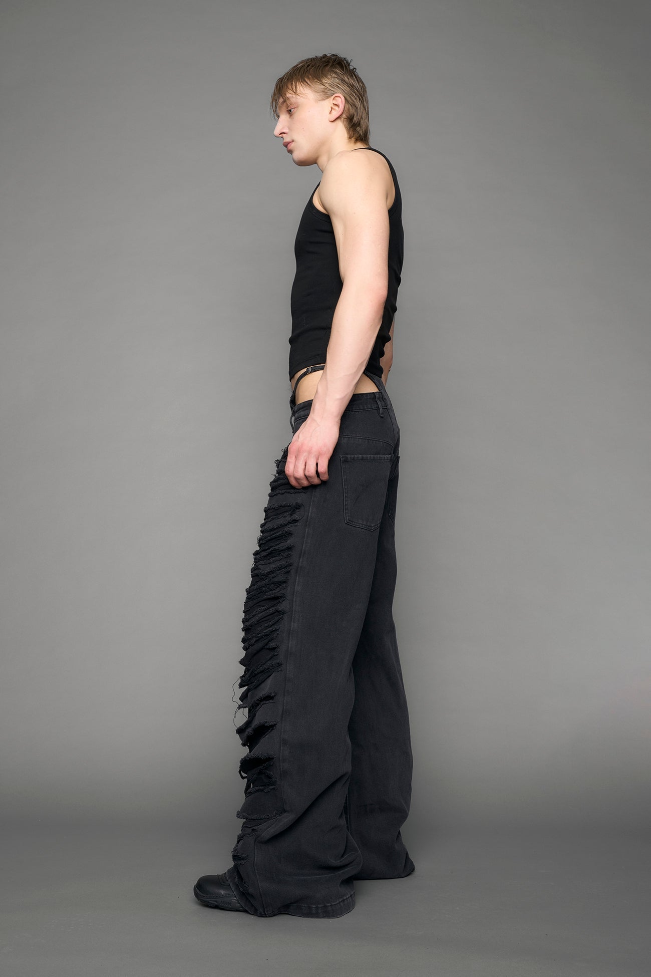 model wearing black denim thong pants used look