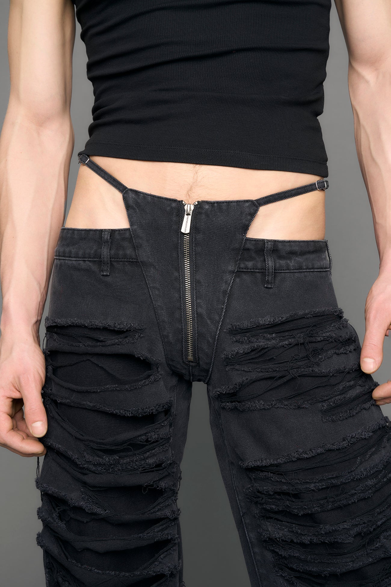 model wearing black denim thong pants used look