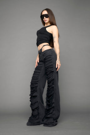 model wearing black denim thong pants used look