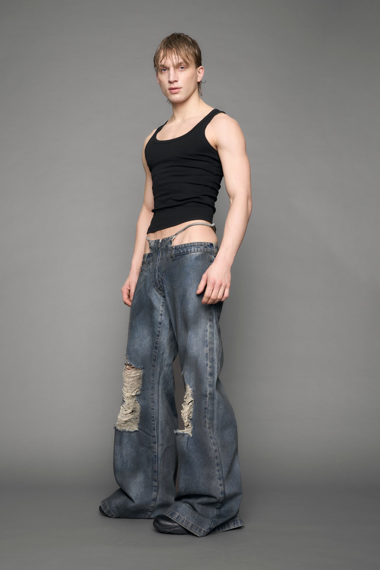 model wearing blue denim thong pants used look