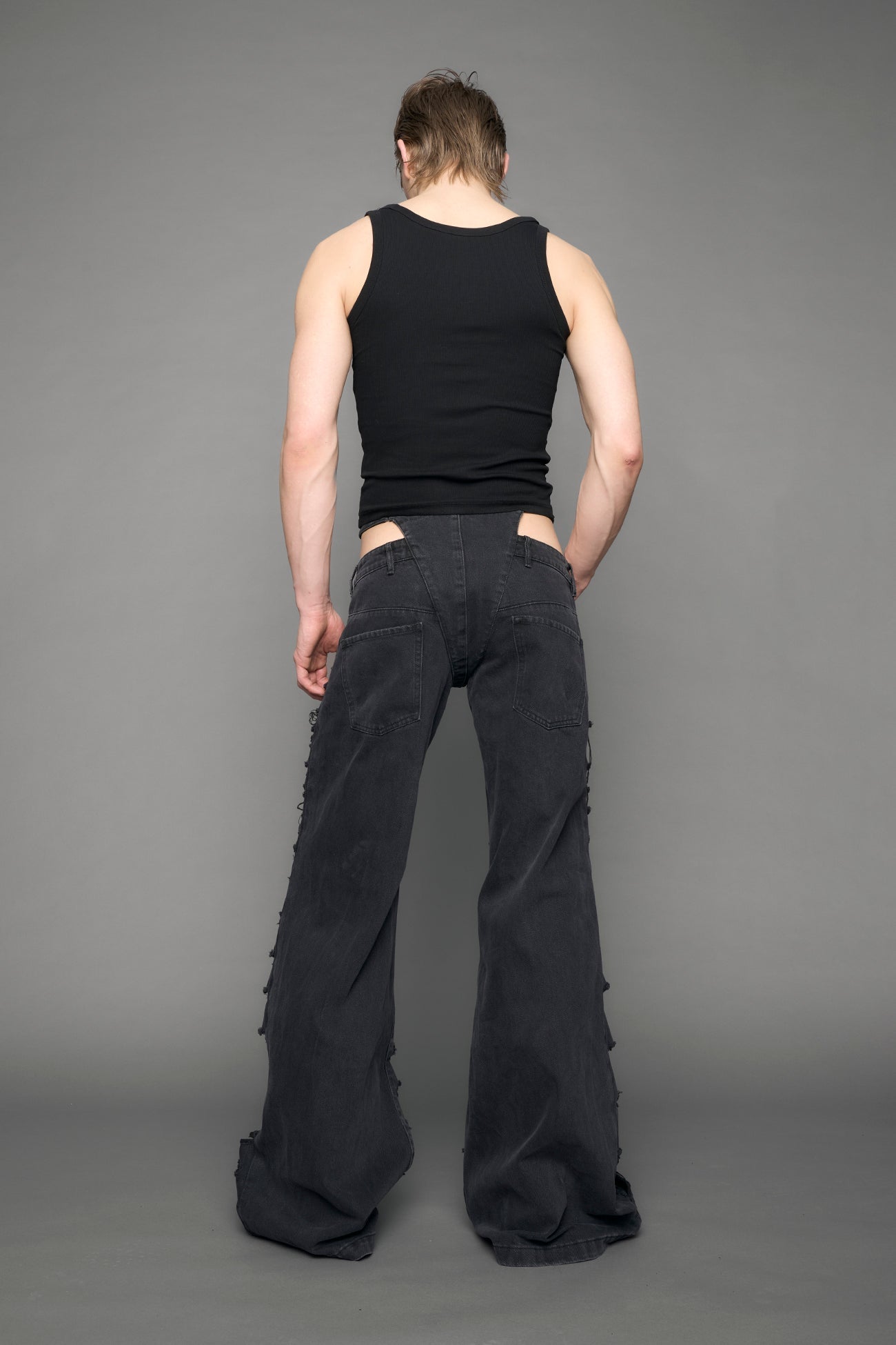 model wearing black denim thong pants used look