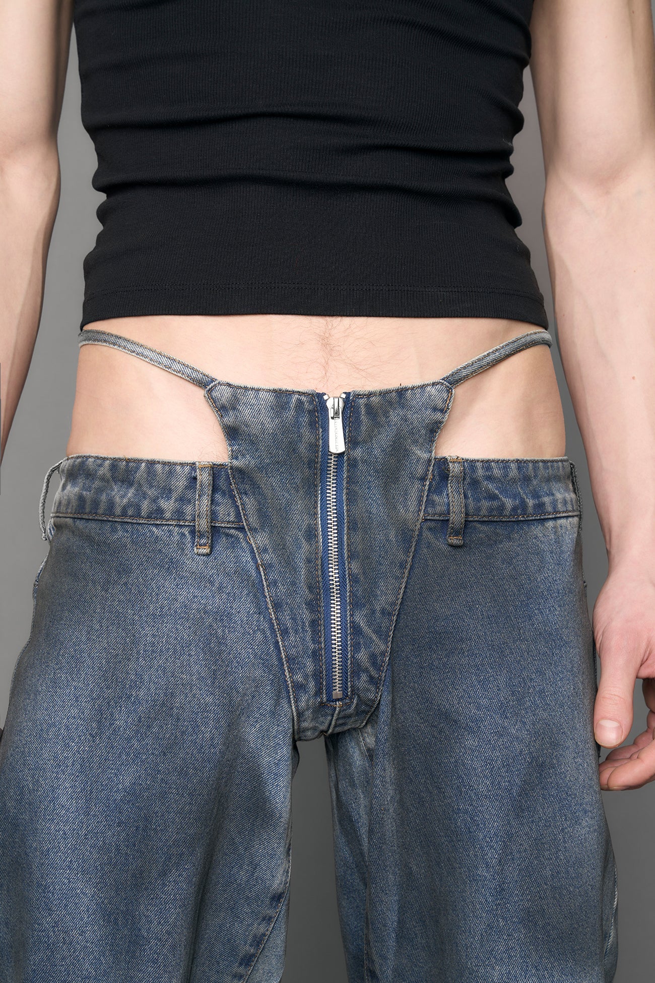 model wearing blue denim thong pants used look