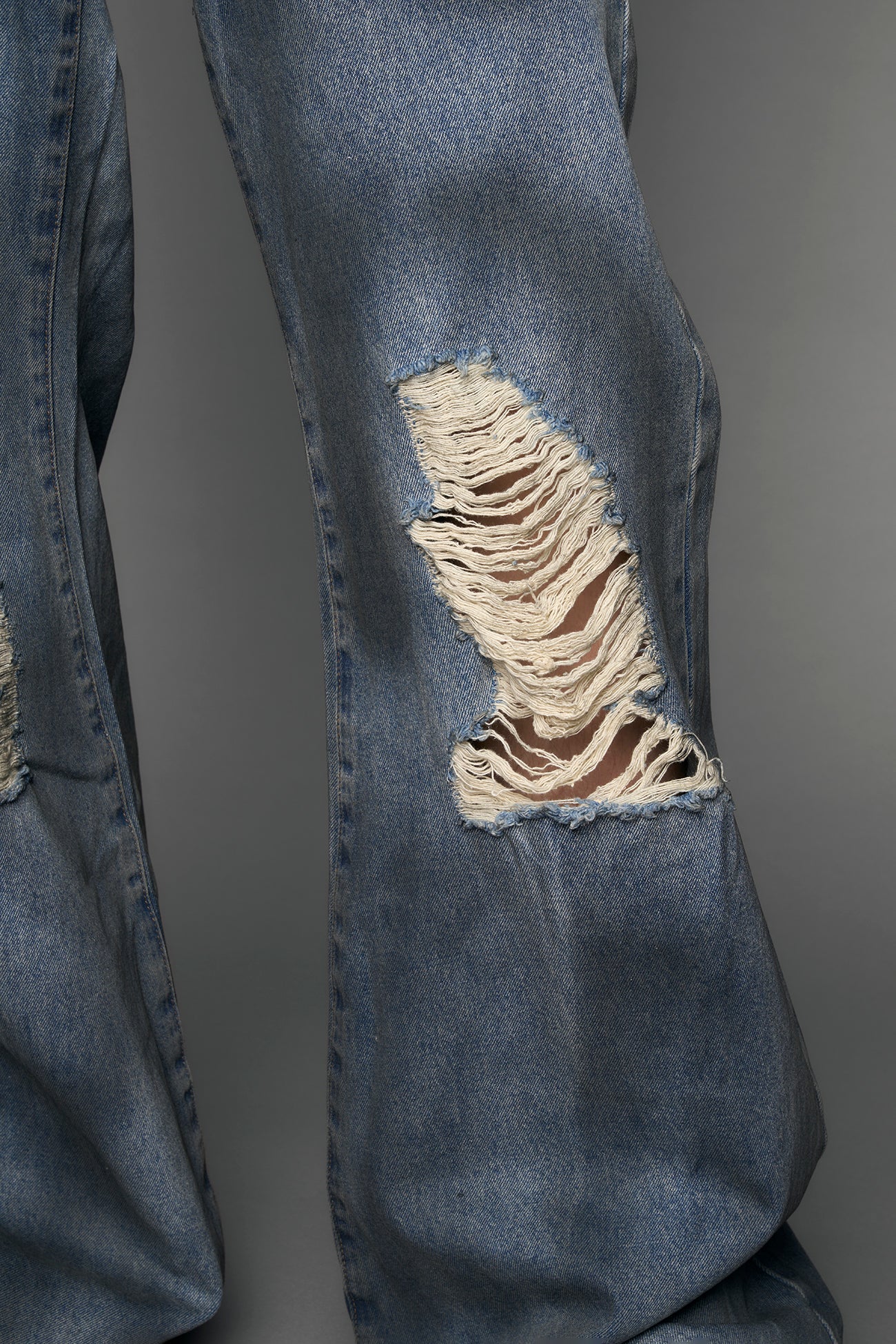 model wearing blue denim thong pants used look
