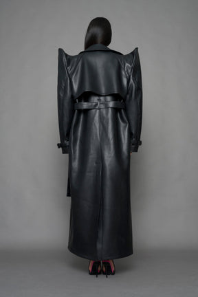 model wearing black vegan leather trench coat with sharp shoulder detail 