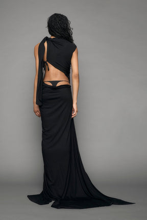model wearing long black draped dress