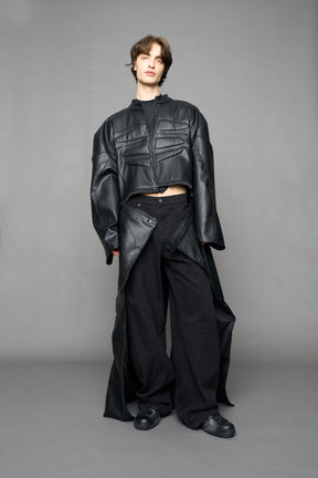 Detachable moto long coat in black vegan black leather inspired by a deconstructed full-body motocross racing suit, featuring padded panel details and a detachable zip design for two-way wear.