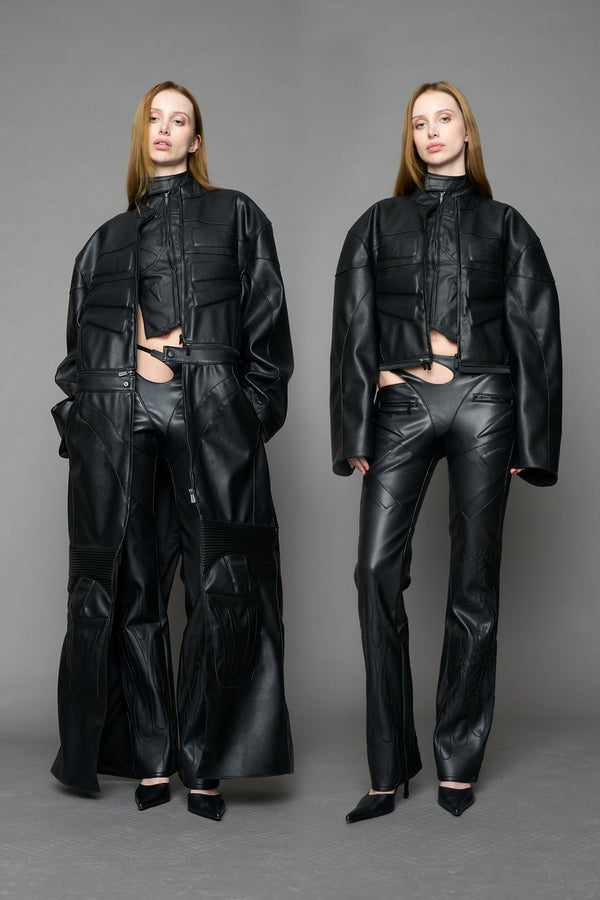 Detachable moto long coat in black black vegan leather inspired by a deconstructed full-body motocross racing suit, featuring padded panel details and a detachable zip design for two-way wear. - BLACK