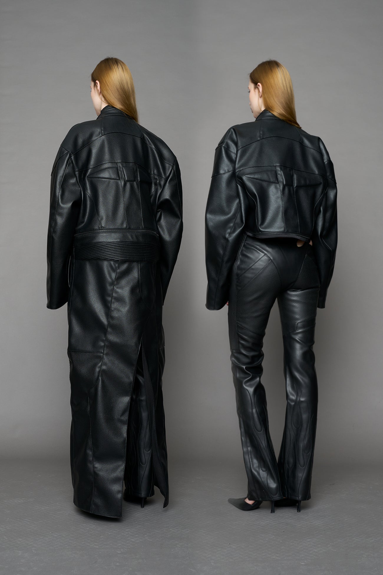 Detachable moto long coat in black vegan black leather inspired by a deconstructed full-body motocross racing suit, featuring padded panel details and a detachable zip design for two-way wear.