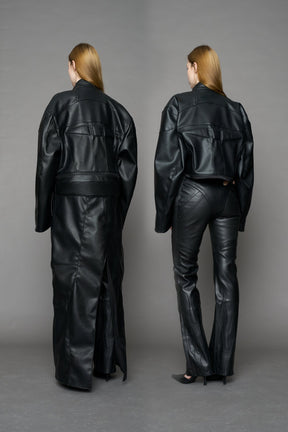 Detachable moto long coat in black vegan black leather inspired by a deconstructed full-body motocross racing suit, featuring padded panel details and a detachable zip design for two-way wear.