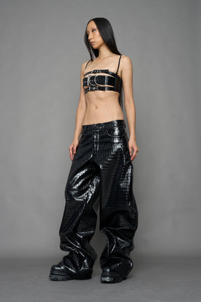 model wearing black vegan leather croc pants