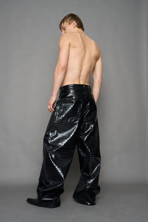 model wearing black vegan leather croc pants