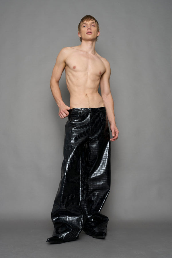 model wearing black vegan leather croc pants