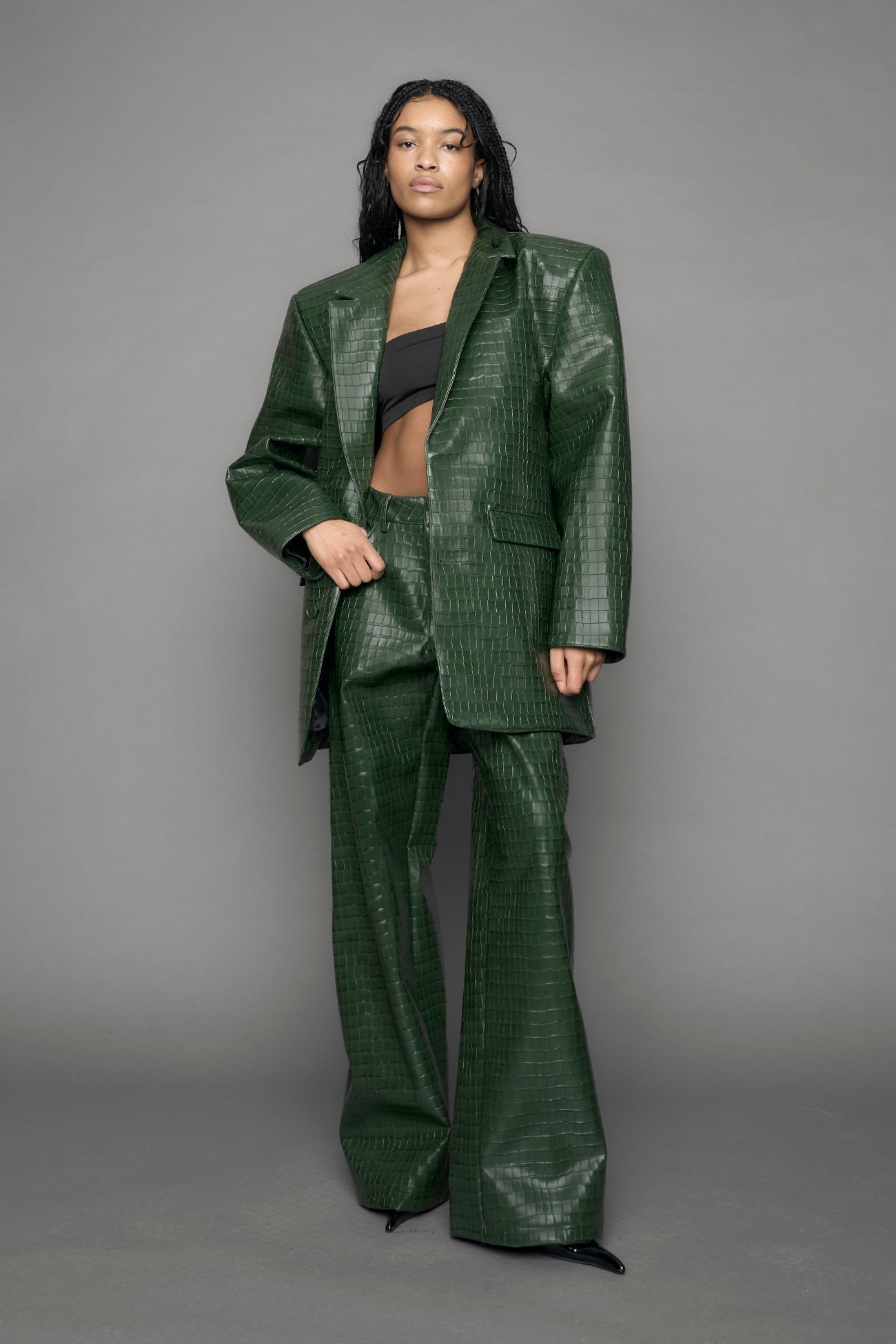 model wearing green croc vegan leather blazer