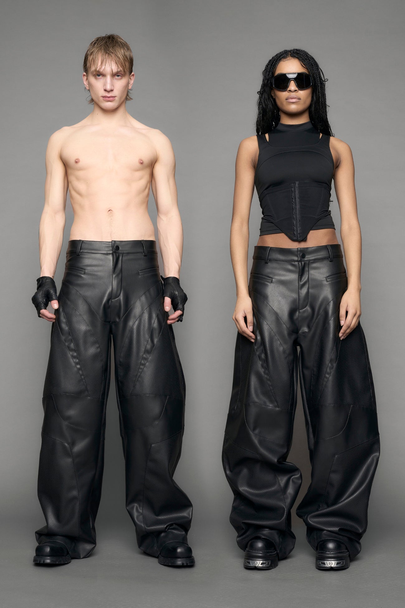 model wearing black vegan leather baggy pants