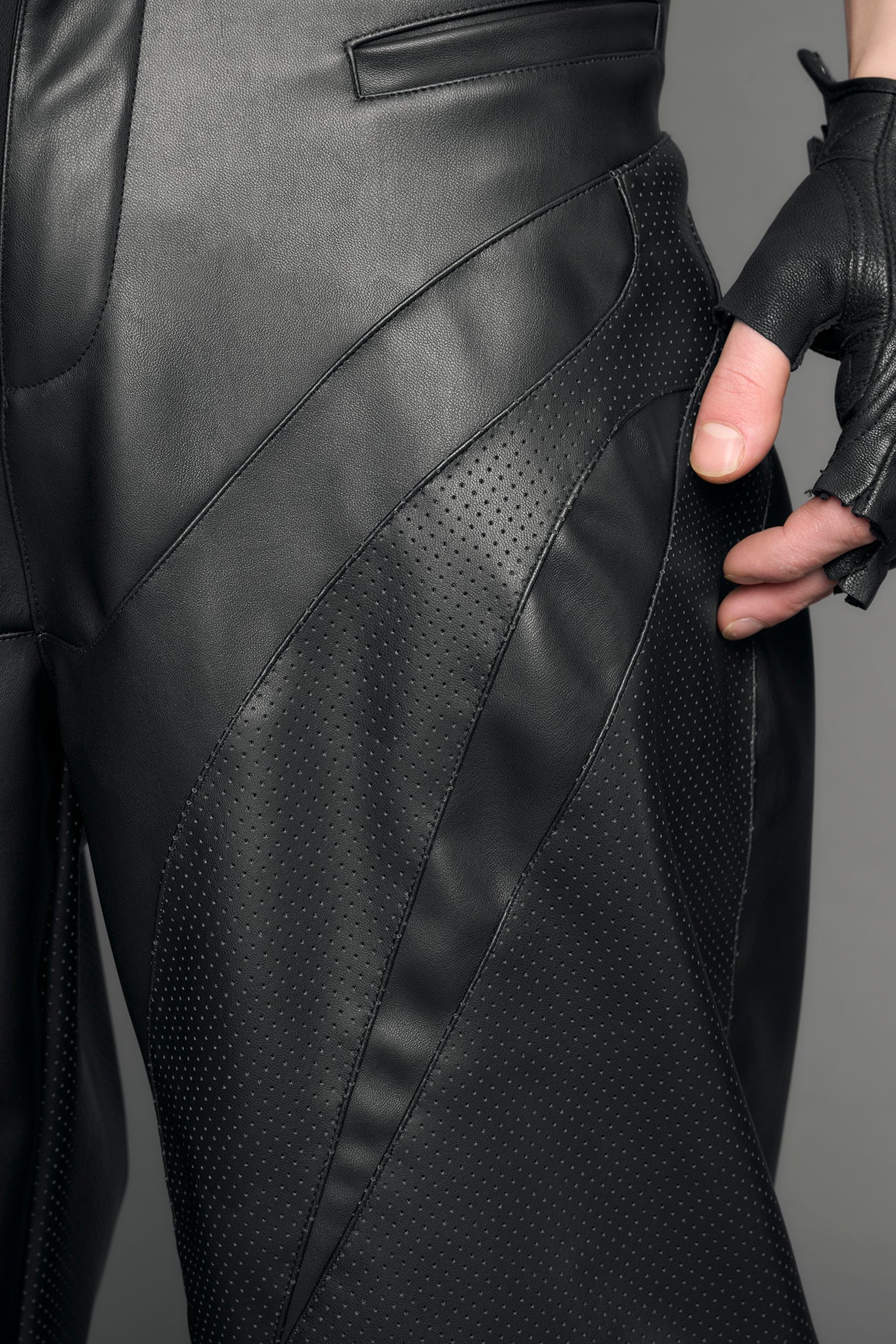 model wearing black vegan leather baggy pants