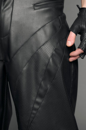 model wearing black vegan leather baggy pants